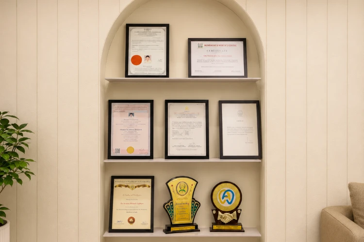Framed certificates, fellowship awards, and professional recognitions displayed on a clinic shelf showcasing Dr Smit A. Desai’s qualifications as an oral cancer surgeon in Ahmedabad and mouth cancer specialist, highlighting expertise in oral oncology and head & neck cancer care.