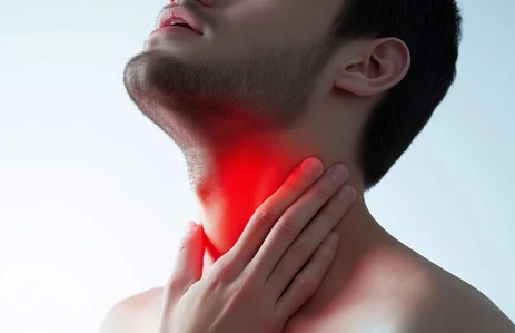 Man holding painful neck area showing symptoms of advanced oral and neck cancer requiring expert surgery at an oral cancer hospital in Ahmedabad.
