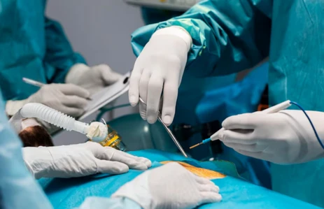 Surgeons using minimally invasive endoscopic techniques for oral and skull base cancer treatment at an oral cancer hospital in Ahmedabad.